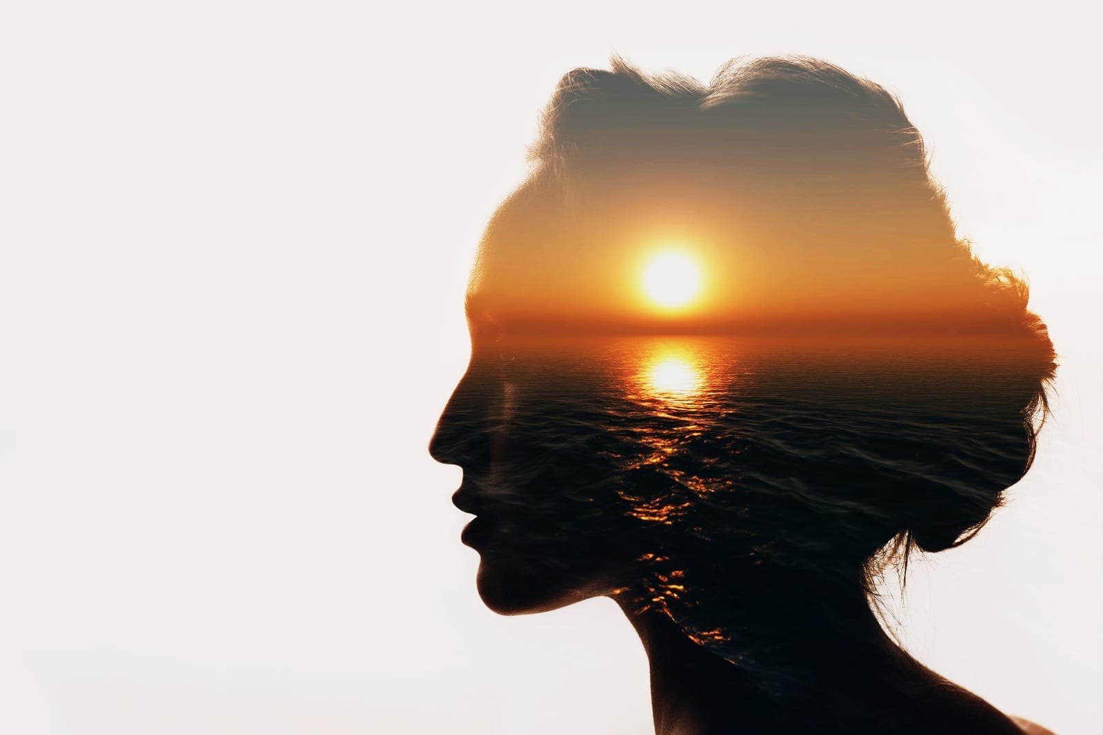 Background image of woman silhouette revealing an ocean sunset