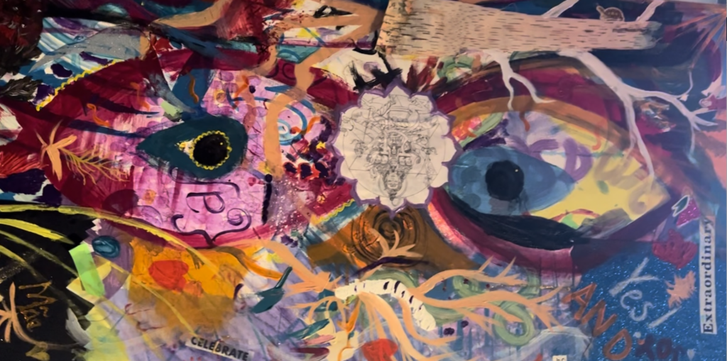 Multi-media piece featuring multi-colored painted eyes